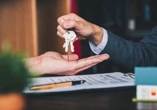 Man Handing Over Keys to Rental Homes in Peoria IL