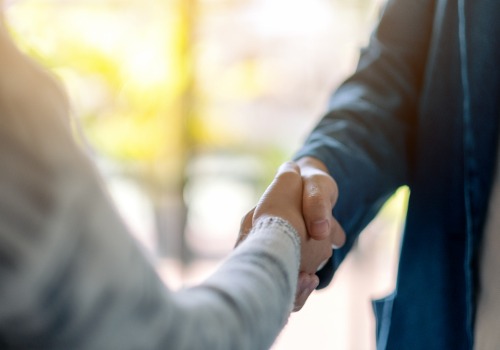 Two People Shaking Hands Over Commercial Properties in Dunlap IL