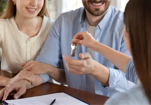 A couple gets their keys from S&S Property Managers in Washington IL